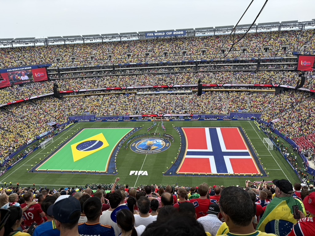 Pre-match ceremony — Brazil and Norway flags on the MetLife pitch, stadium packed in yellow